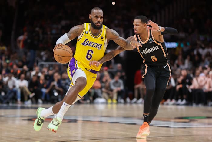 Hawks guard Dejounte Murray defends Lakers forward LeBron James.
